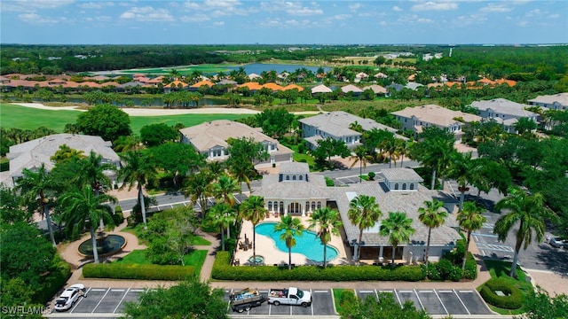 drone / aerial view featuring a water view, a residential view, and golf course view