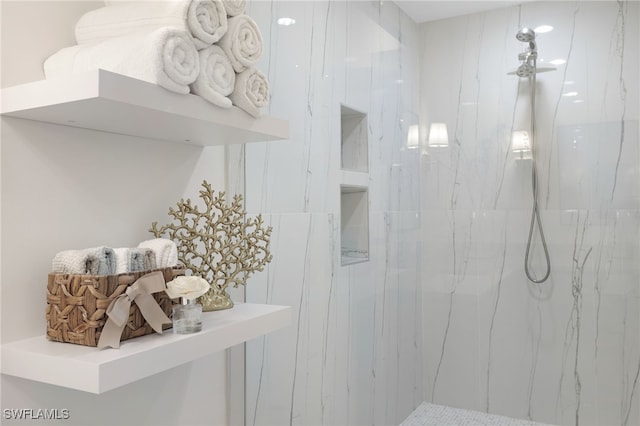 bathroom with a marble finish shower