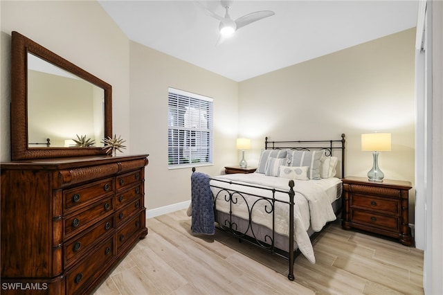 bedroom featuring baseboards, light wood-style flooring, and ceiling fan