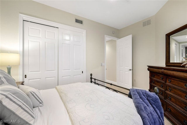 bedroom featuring visible vents and a closet