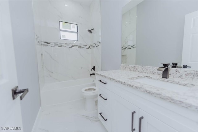 full bathroom with vanity, tiled shower / bath combo, and toilet