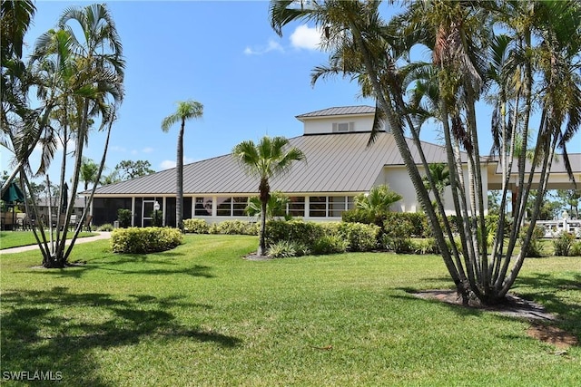 4261 Ute Ct, Estero, FL 33928 - view of front of home featuring metal roof, a front lawn, and a standing seam roof