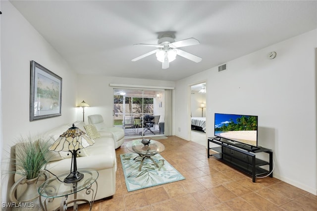 tiled living room with visible vents and a ceiling fan