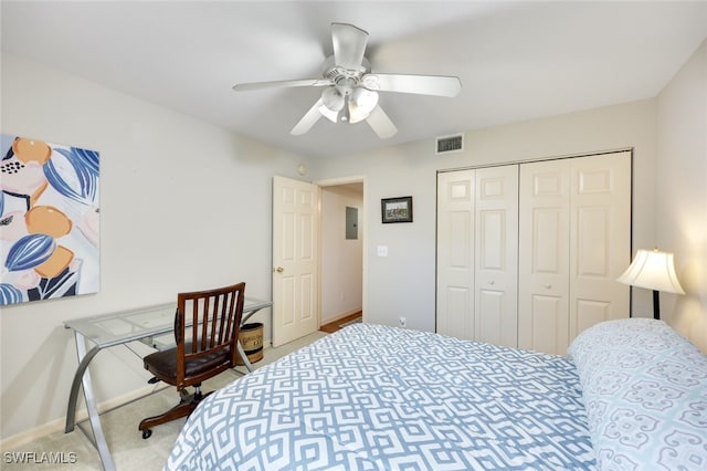 carpeted bedroom featuring baseboards, a closet, visible vents, and a ceiling fan