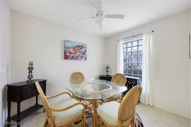 dining room featuring ceiling fan, light tile patterned flooring, and baseboards