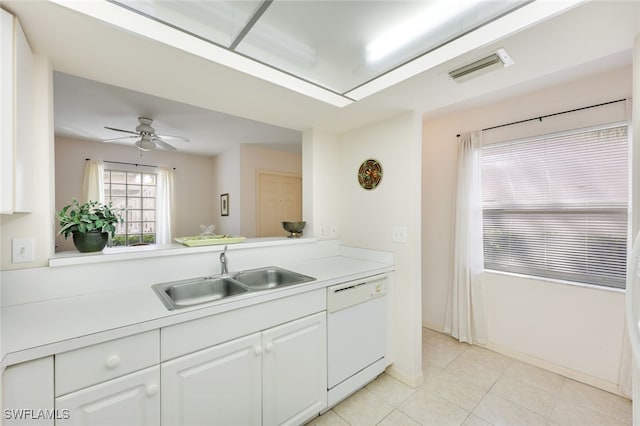 kitchen featuring light countertops, light tile patterned flooring, white dishwasher, a sink, and white cabinetry