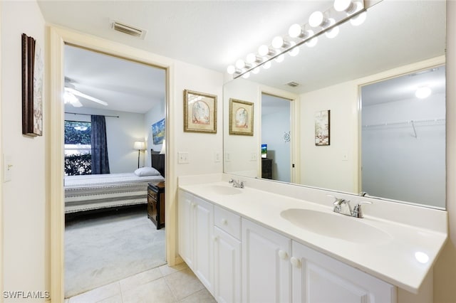 ensuite bathroom with ensuite bath, visible vents, and a sink