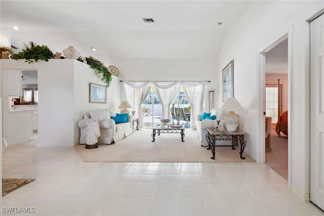 living area with visible vents and light tile patterned flooring