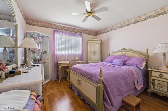 bedroom featuring ceiling fan and wood finished floors