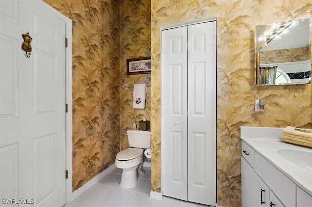 bathroom with wallpapered walls, a closet, and vanity