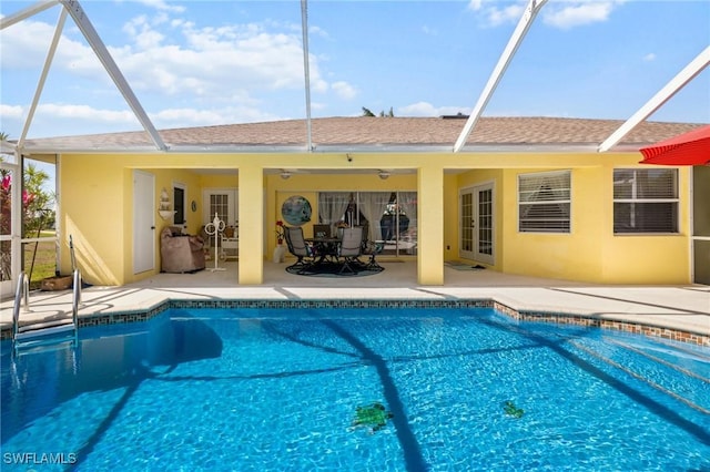 back of property with ceiling fan, glass enclosure, a patio area, and stucco siding