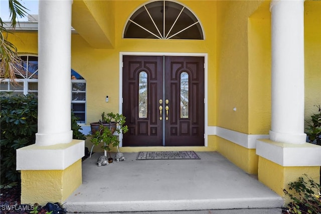 doorway to property with stucco siding