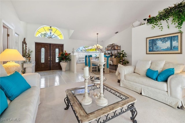 living room with a chandelier, lofted ceiling, and light tile patterned flooring