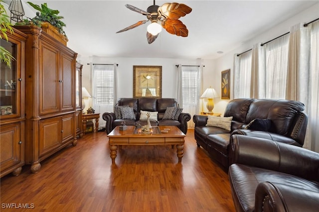 living room with dark wood-style flooring and a ceiling fan