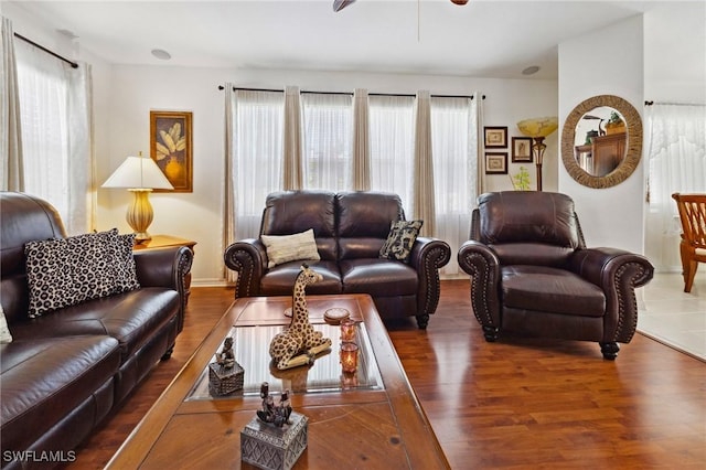 living area featuring dark wood-style floors and ceiling fan