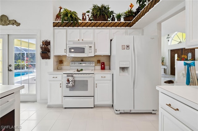 kitchen with white cabinets, white appliances, and light countertops