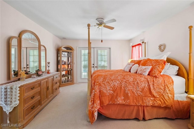 bedroom featuring light carpet, access to exterior, and a ceiling fan