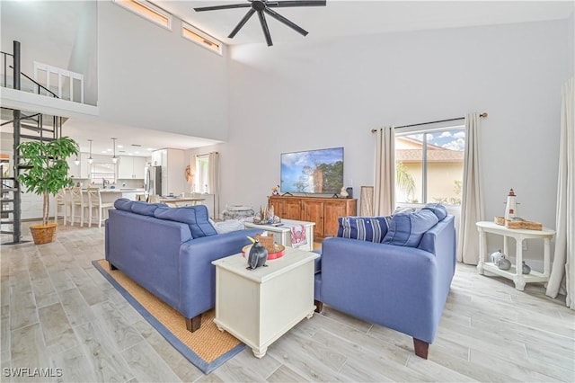 living room with light wood-style floors and ceiling fan