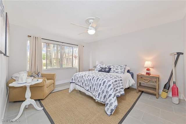 bedroom featuring light tile patterned floors, baseboards, and a ceiling fan