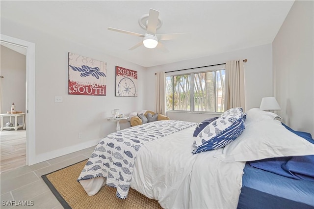 bedroom featuring light tile patterned floors, ceiling fan, and baseboards