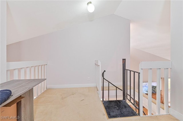 bonus room featuring lofted ceiling, baseboards, and light colored carpet