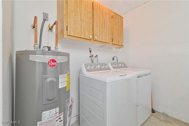 clothes washing area with washing machine and dryer, electric water heater, and cabinet space