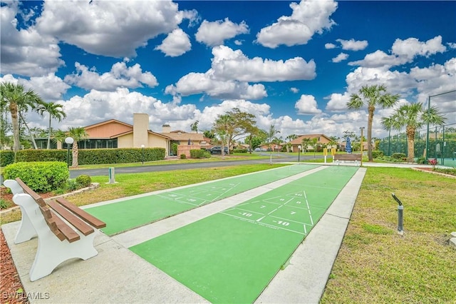 surrounding community with shuffleboard and a lawn