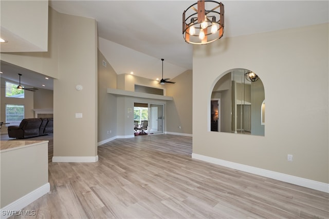 unfurnished living room featuring light hardwood / wood-style floors, high vaulted ceiling, and ceiling fan