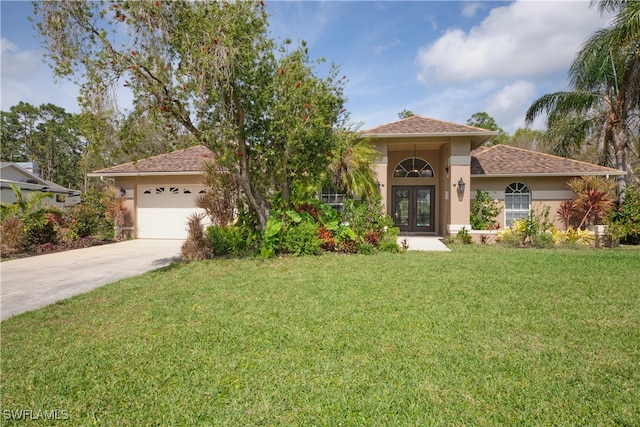 mediterranean / spanish house featuring a front lawn, french doors, and a garage