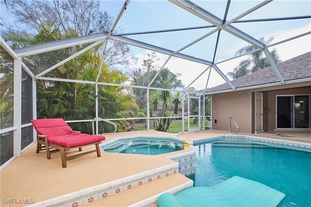 view of swimming pool featuring an in ground hot tub, a patio, and a lanai