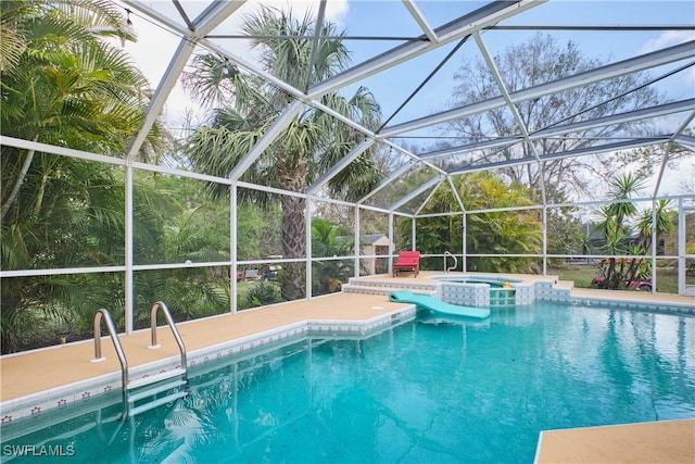 view of pool featuring an in ground hot tub and a lanai