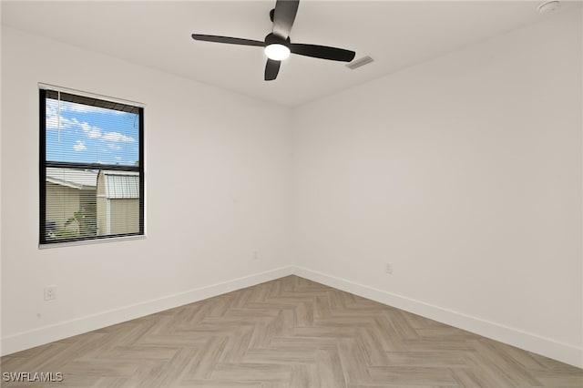 empty room with baseboards, visible vents, and a ceiling fan