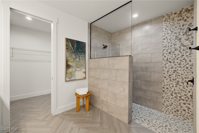 full bathroom with a spacious closet, baseboards, a walk in shower, and recessed lighting