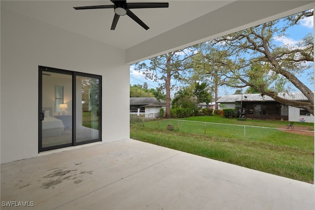 view of patio featuring a ceiling fan and fence