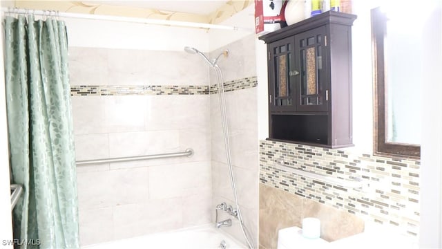 bathroom with shower / bath combo with shower curtain