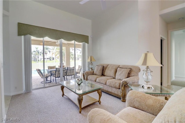 carpeted living room with ceiling fan