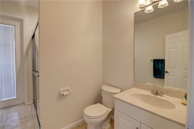 bathroom featuring tile patterned floors, vanity, and toilet