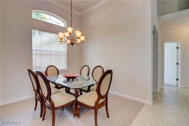 tiled dining space with crown molding and a chandelier