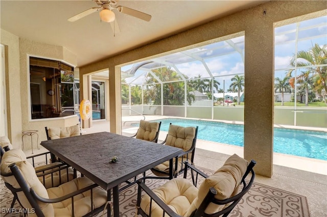 sunroom with a pool and ceiling fan