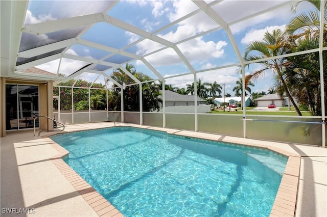 view of pool featuring a patio and glass enclosure