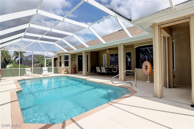 view of pool featuring ceiling fan, a lanai, and a patio