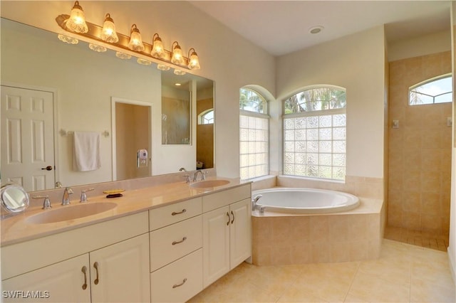 bathroom with vanity, tile patterned floors, and shower with separate bathtub