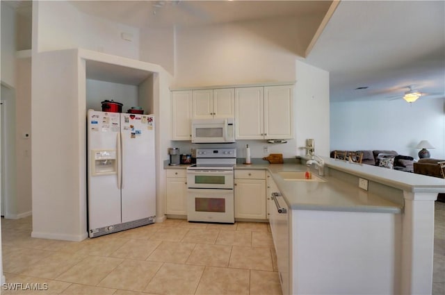 kitchen with sink, white cabinetry, light tile patterned floors, kitchen peninsula, and white appliances