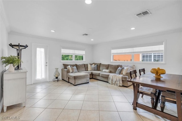 living room featuring light tile patterned floors, ornamental molding, visible vents, and recessed lighting