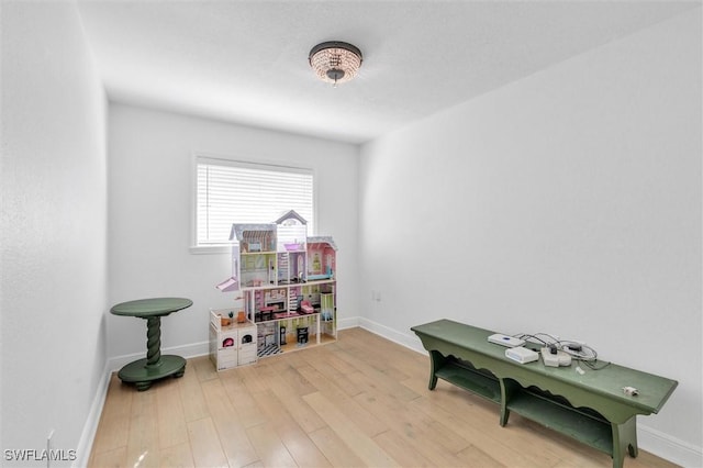 game room featuring wood finished floors and baseboards