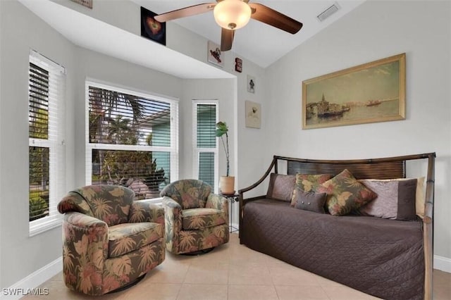 bedroom with ceiling fan, vaulted ceiling, and light tile patterned floors