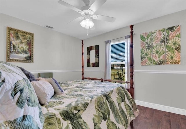 bedroom with dark hardwood / wood-style floors and ceiling fan