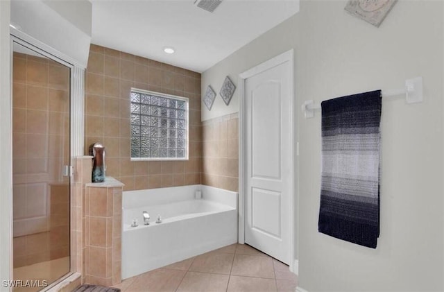 bathroom with tile patterned flooring and separate shower and tub