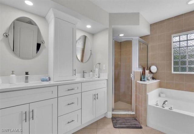 bathroom with tile patterned floors, plus walk in shower, and vanity