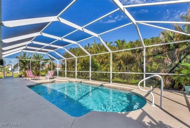 view of pool featuring a patio area and glass enclosure